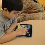 Child playing with an iPad