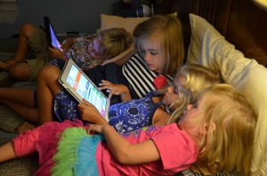 Kids with ipad in bed