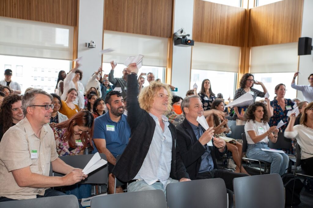 Following the presentations, attendees were asked to write any questions or comments on paper airplanes and fly them to the front of the room.