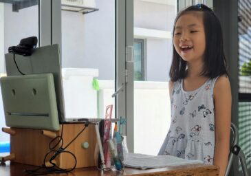 Young girl speaking into computer