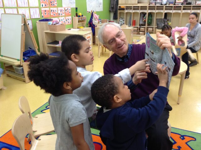 Herb Ginsburg reading to young children at Cooney School
