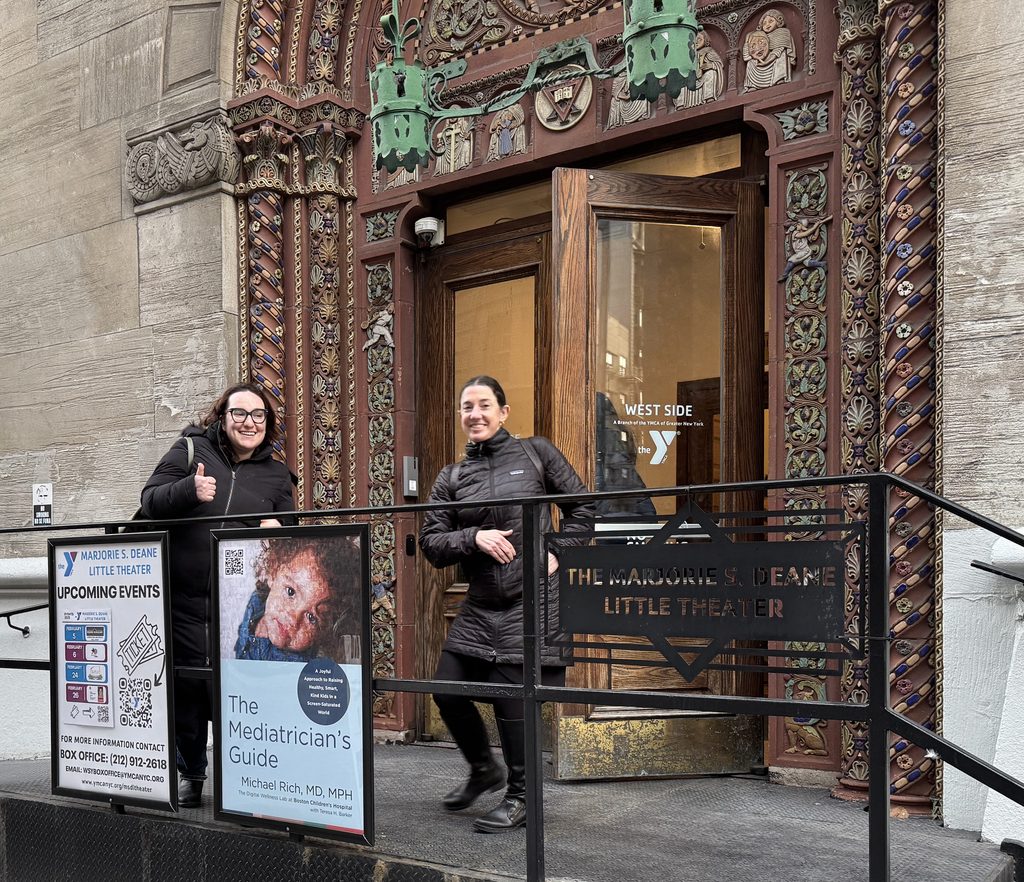Two Cooney Center team members enter the West Side YMCA for an event
